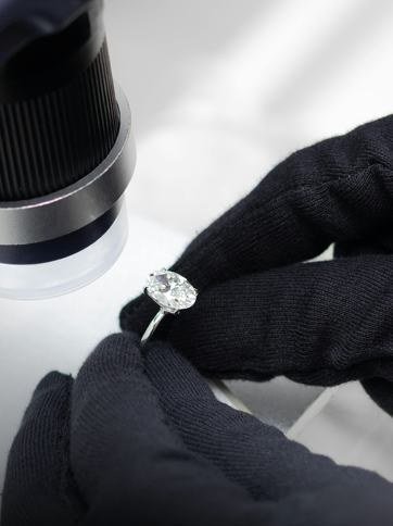 Close-up of a diamond ring being examined