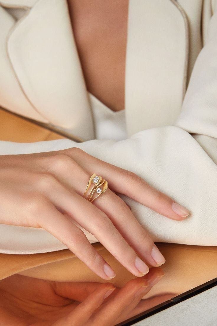Hands wearing gold rings